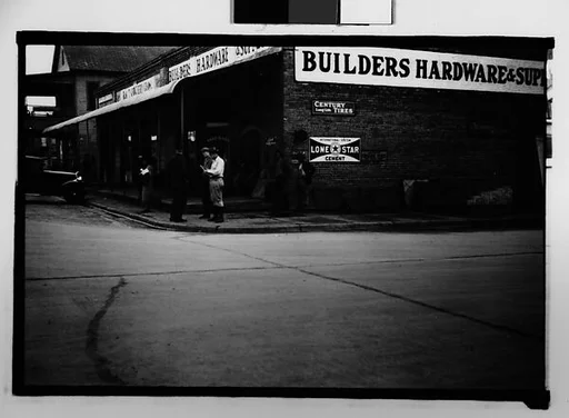 [Street Scene in Front of Builders Hardware Store, From Car, Mobile Vicinity, Alabama]