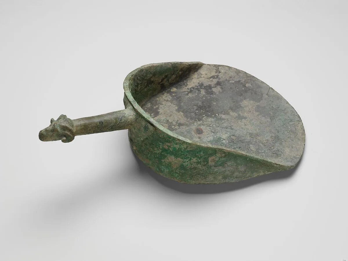 Bronze shovel with a handle terminating in a ram's head — Unknown