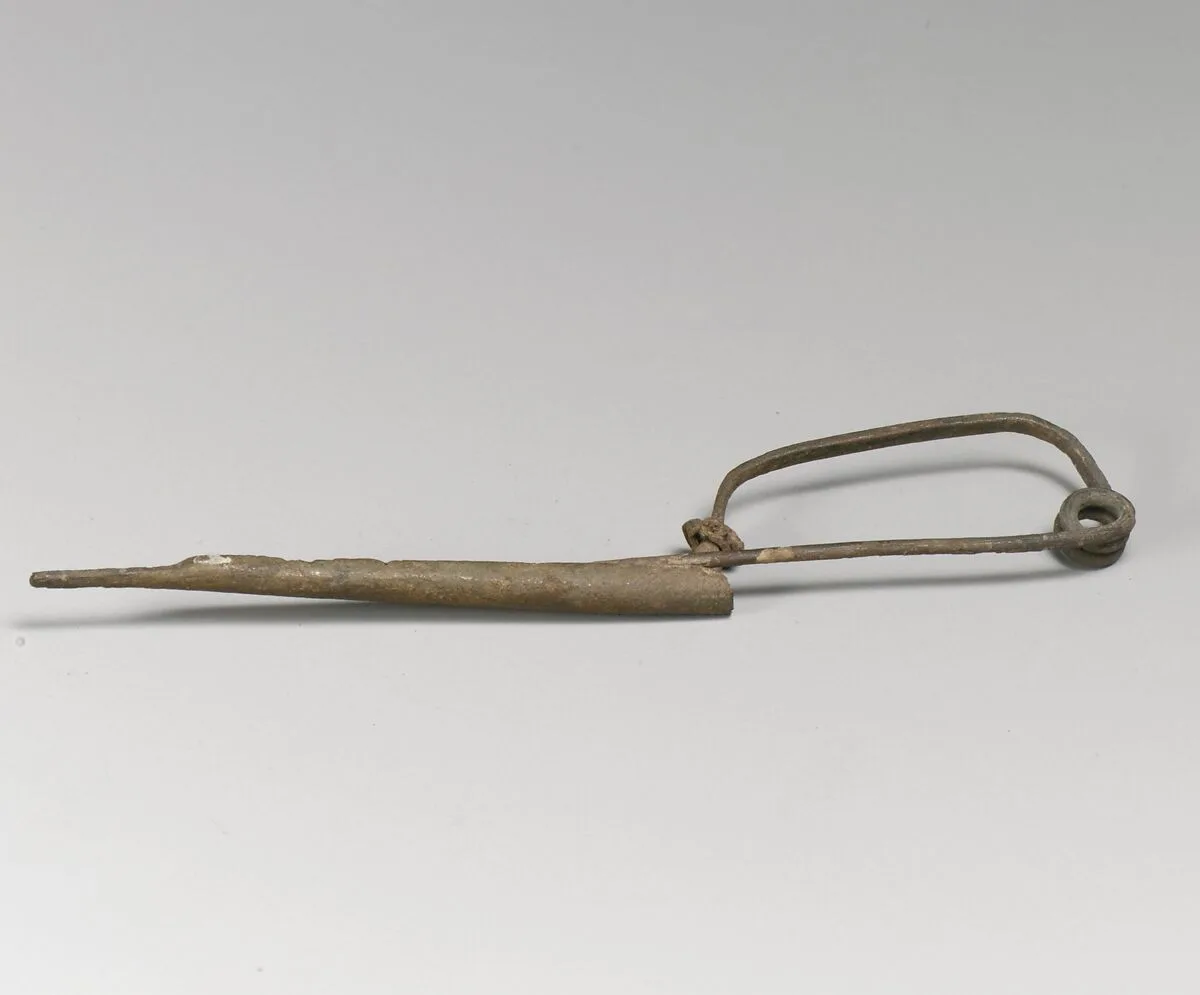 Fibula with silver bead — Unknown