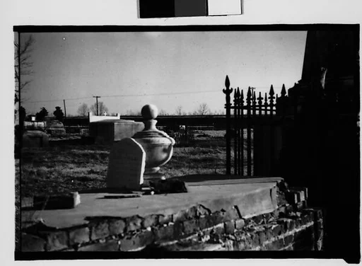 [Gravestone and Marker on Ledge in Cemetery Yard, Louisiana]