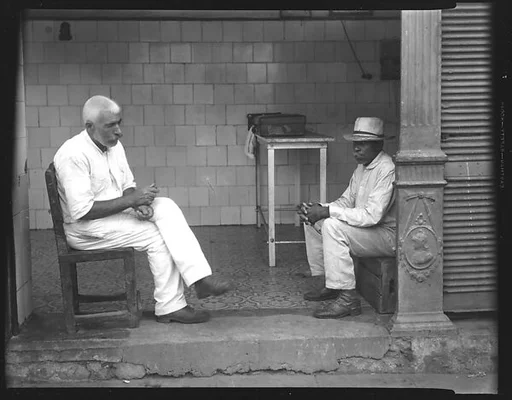 [Two Men Seated in Entryway, Havana]