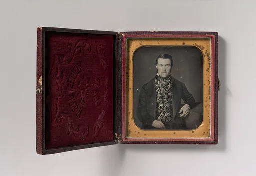 [Seated Man in Floral Vest]