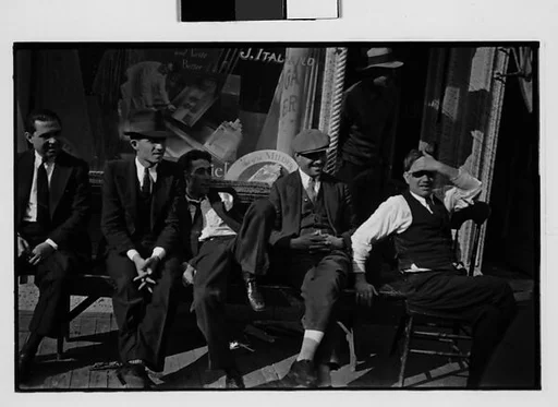 [Two 35mm Film Frames: Men Seated on Bench Outside Tobacconist Shop, New York City]