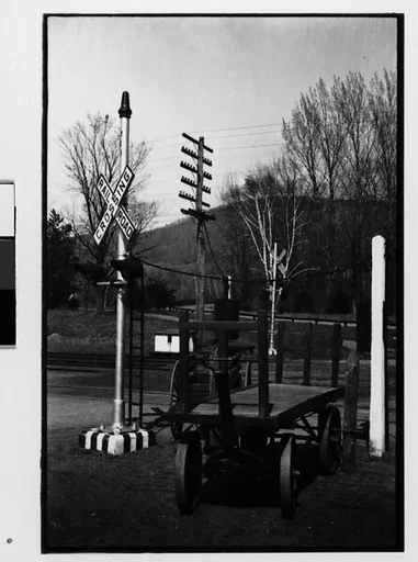 [Two 35mm Film Frames: Railroad Crossing and Flatbed Wagons, Copake, New York]