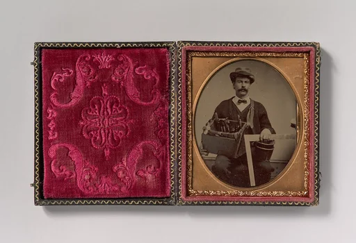 [Carpenter Holding a Bag of Tools and a Square]