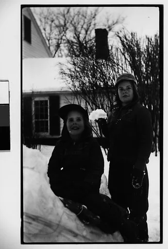 [Two Children, Possibly Mabry Girls, on Snowbank in Front of House]