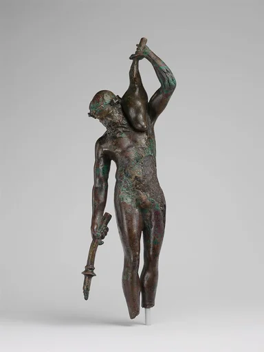 Bronze statuette of a satyr with a torch and wineskin