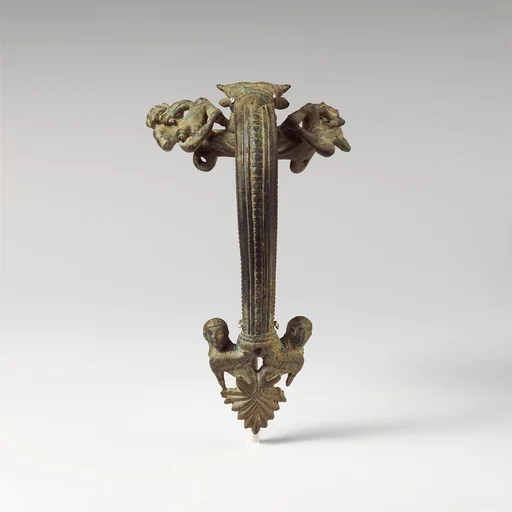 Bronze oinochoe (jug) handle with satyrs flanking a head of Acheloos