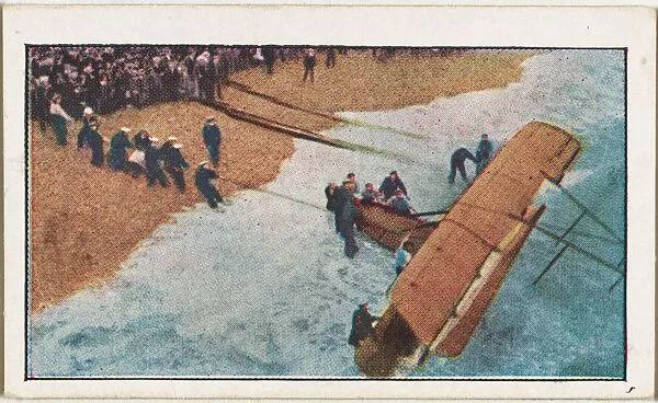 Card No. 235, Pulling Ashore a British War Aeroplane Wrecked During a Scouting Trip Over the North Sea, from the World War I Scenes series (T121) issued by Sweet Caporal Cigarettes — American Tobacco Company|Underwood & Underwood