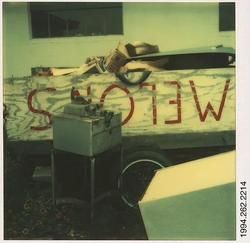 [Sign in Trash Heap: "MELONS", Destin, Florida]