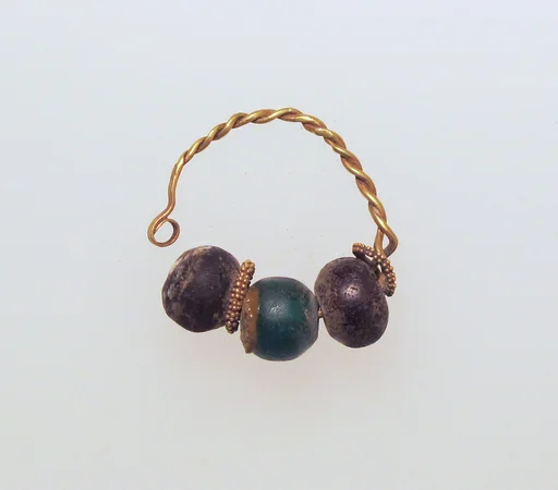 Gold earring with glass beads