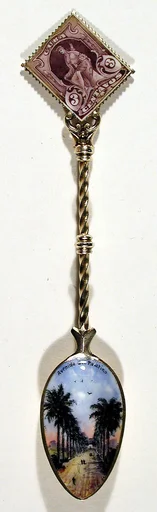 Souvenir spoon with view of a long avenue and finial in the form of a postage stamp