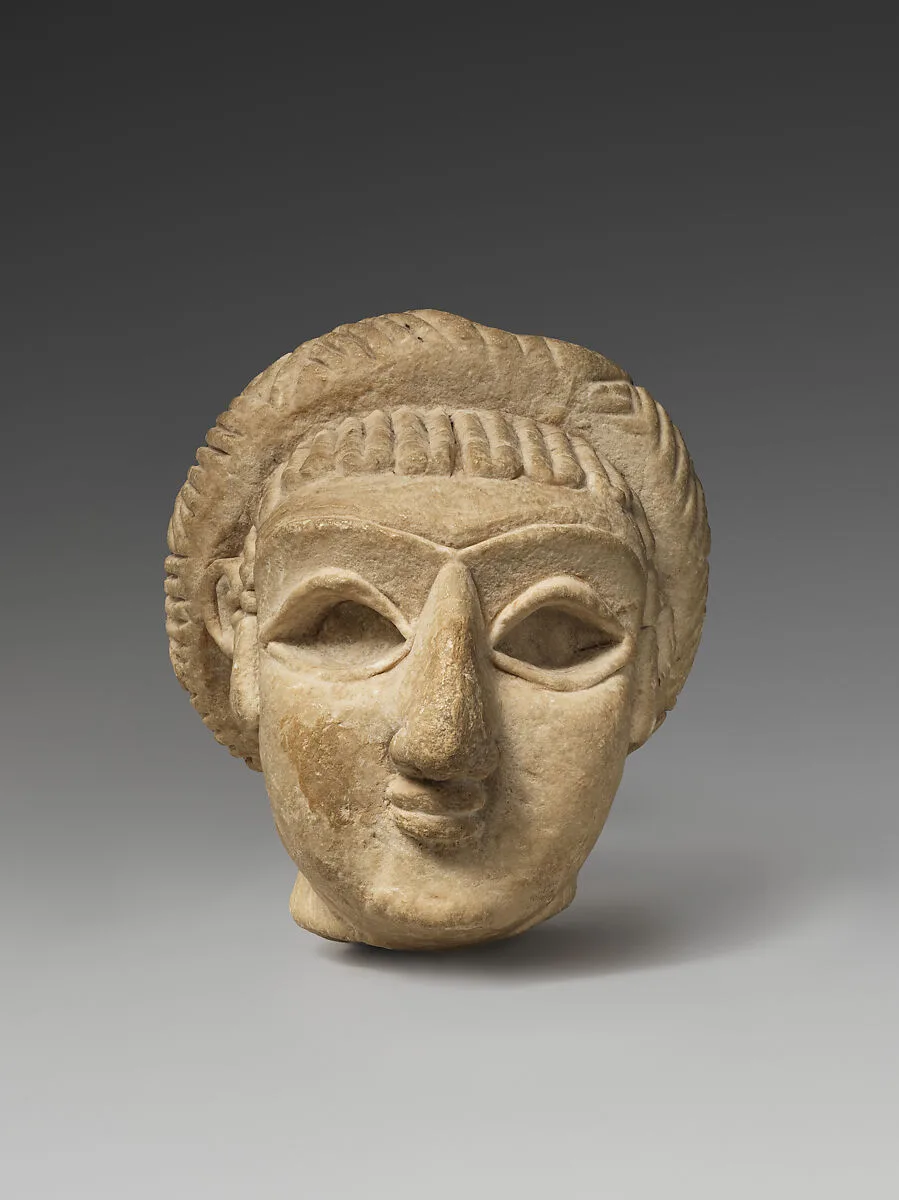 Female head with elaborate hairstyle — Unknown