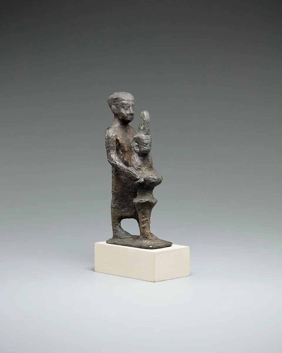 Individual holding a Maat bust on a stand — Unknown