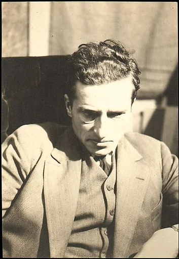 [Paul Grotz, Wearing Three Piece Suit and Monocle, Looking Down]