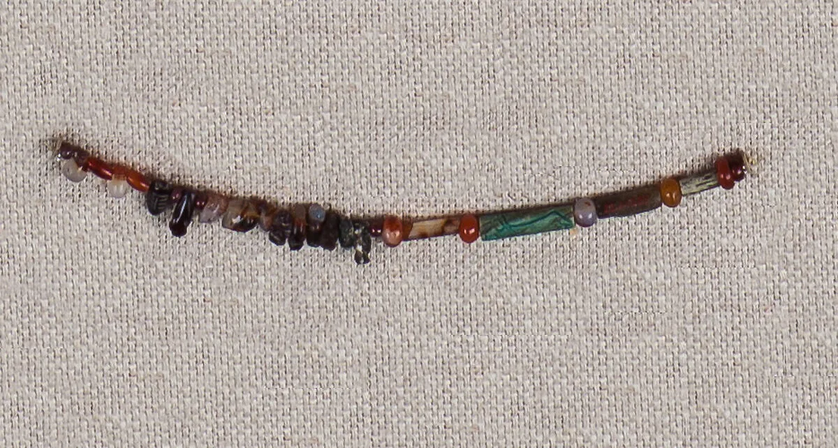 String of beads and amulets — Unknown