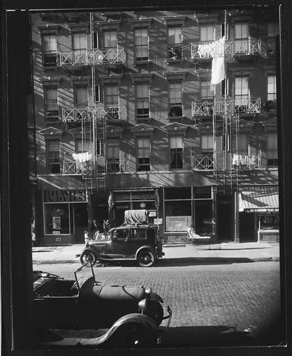 [Apartment Building with Ground Floor Shops and Parked Cars in Front, 41-43 Carmine Street, New York City]