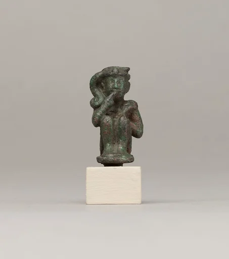 Crouching child god holding scepter