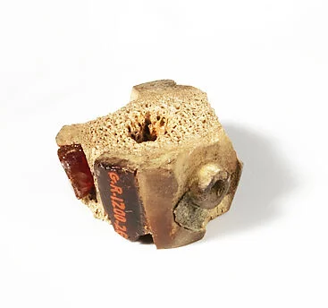 Bone and amber segment from a bronze fibula (safety pin)
