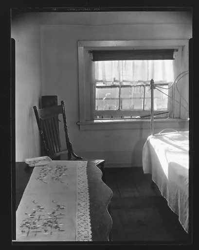 [Bedroom Interior with Table and Chair in Boarding House on Hudson Street, Residence of John Cheever, New York City]