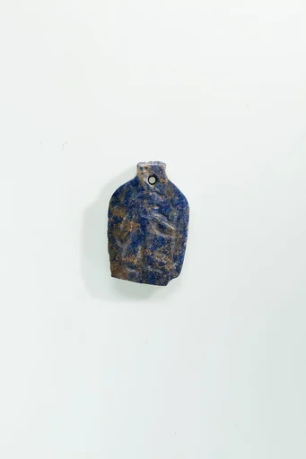 Plaque with a striding man from string of amulets