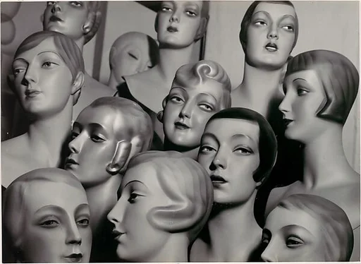 [Arrangement of 12 Female Mannequin Heads, Each with Distinct Physiognomy and Period Hair Style]
