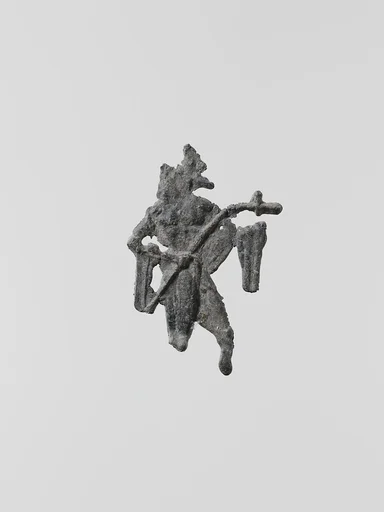 Lead figure of a man with a spear or scepter