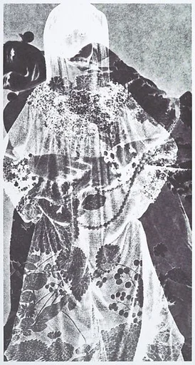 [Pale figure in flowered robe]