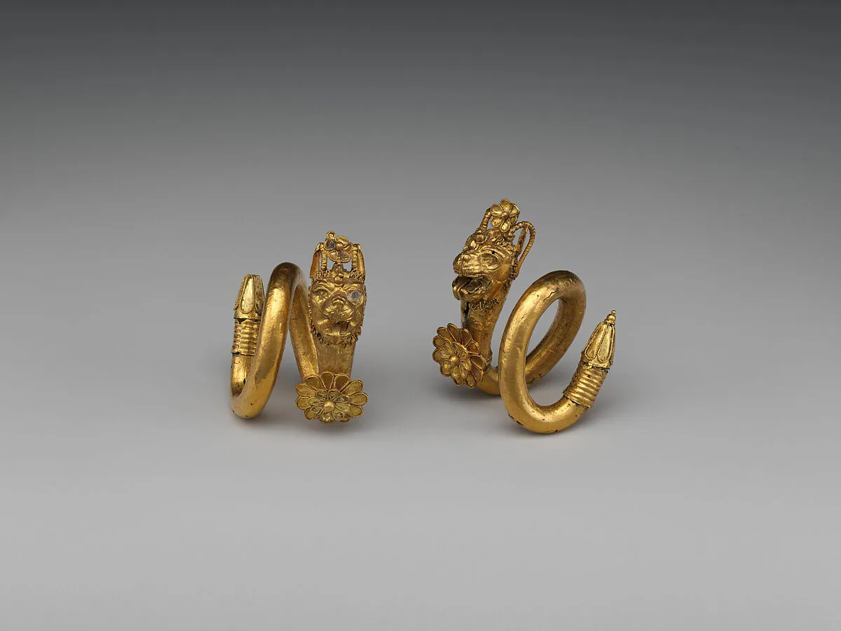 Gold and copper alloy spiral earring with lion-griffin head terminal — Unknown