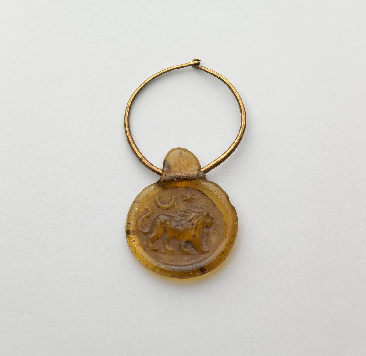Glass stamped disk pendant with gold hoop — Unknown