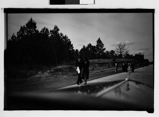 [People Walking by Side of Road, From Moving Automobile, Macon, Georgia]