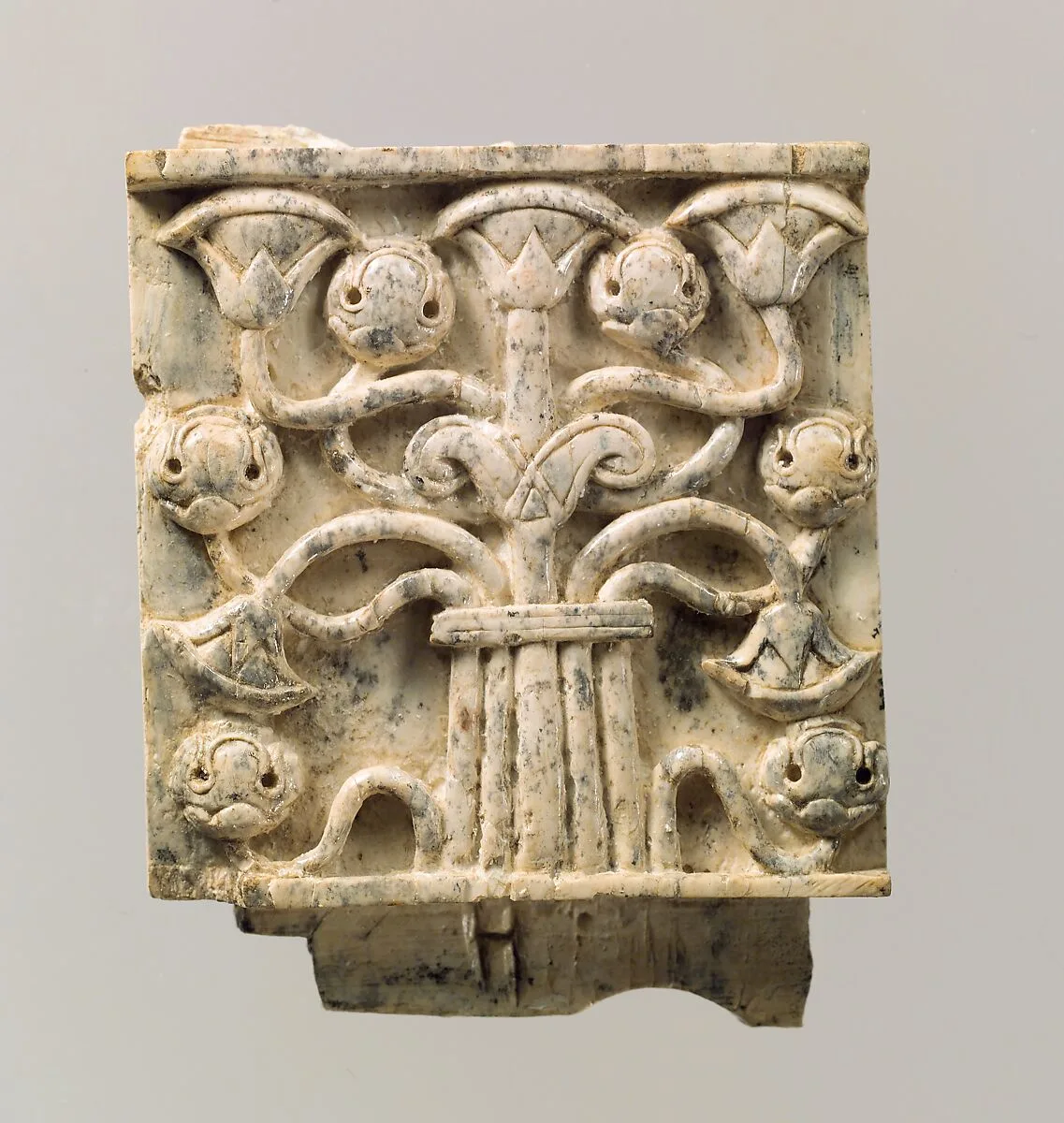 Furniture plaque carved in relief with stylized tree — Unknown