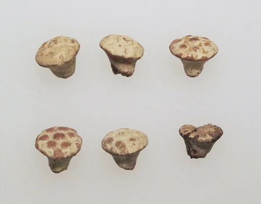 Pendant of gilded clay
