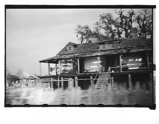 [Wooden House on Raised Platform, From Moving Automobile, Louisiana]