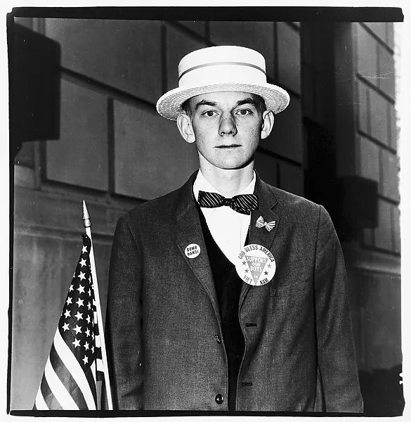 Boy with a straw hat waiting to march in a pro-war parade, N.Y.C. — Diane Arbus