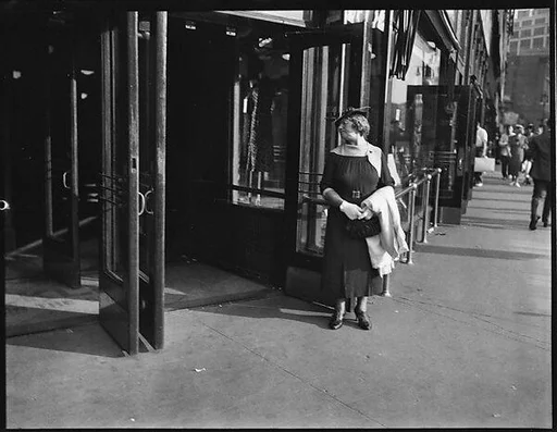 [Woman Outside Entrance of S. Klein-on-the-Square Department Store, Union Square East, New York City]