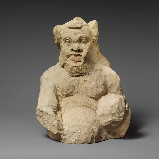 Fragment of a partly unfinished limestone statuette of a silen