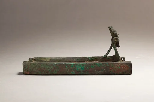 Atum as a human-headed cobra surmounting a box for an animal mummy