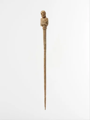Bone hairpin with bust of a woman