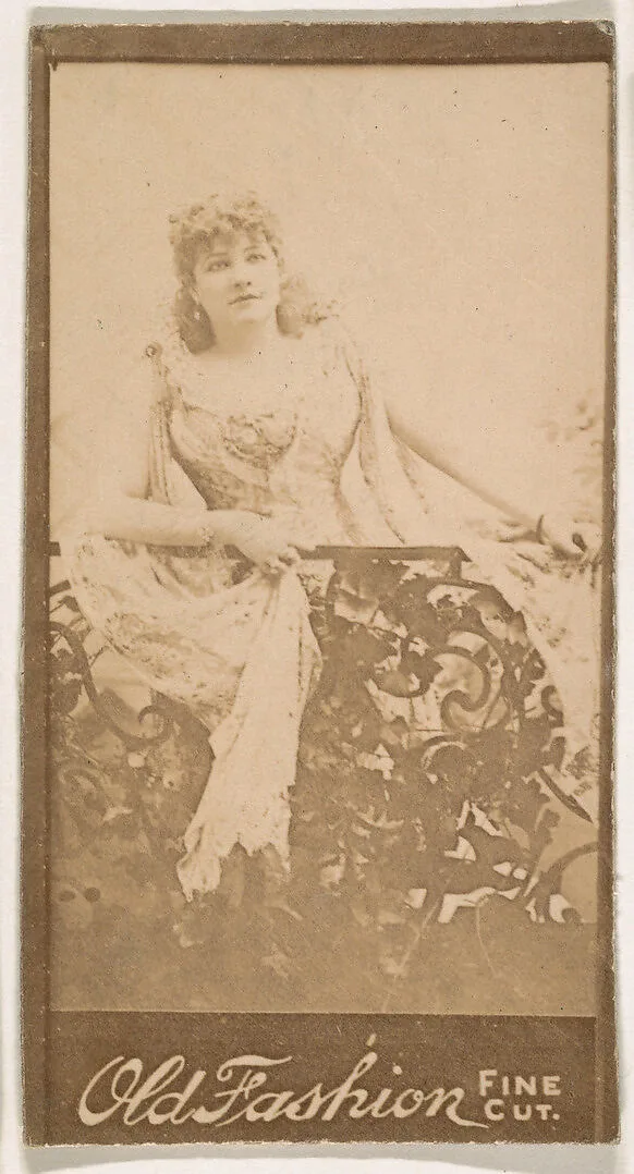 Actress standing behind iron railing, from the Actresses series (N664) promoting Old Fashion Fine Cut Tobacco — Unknown