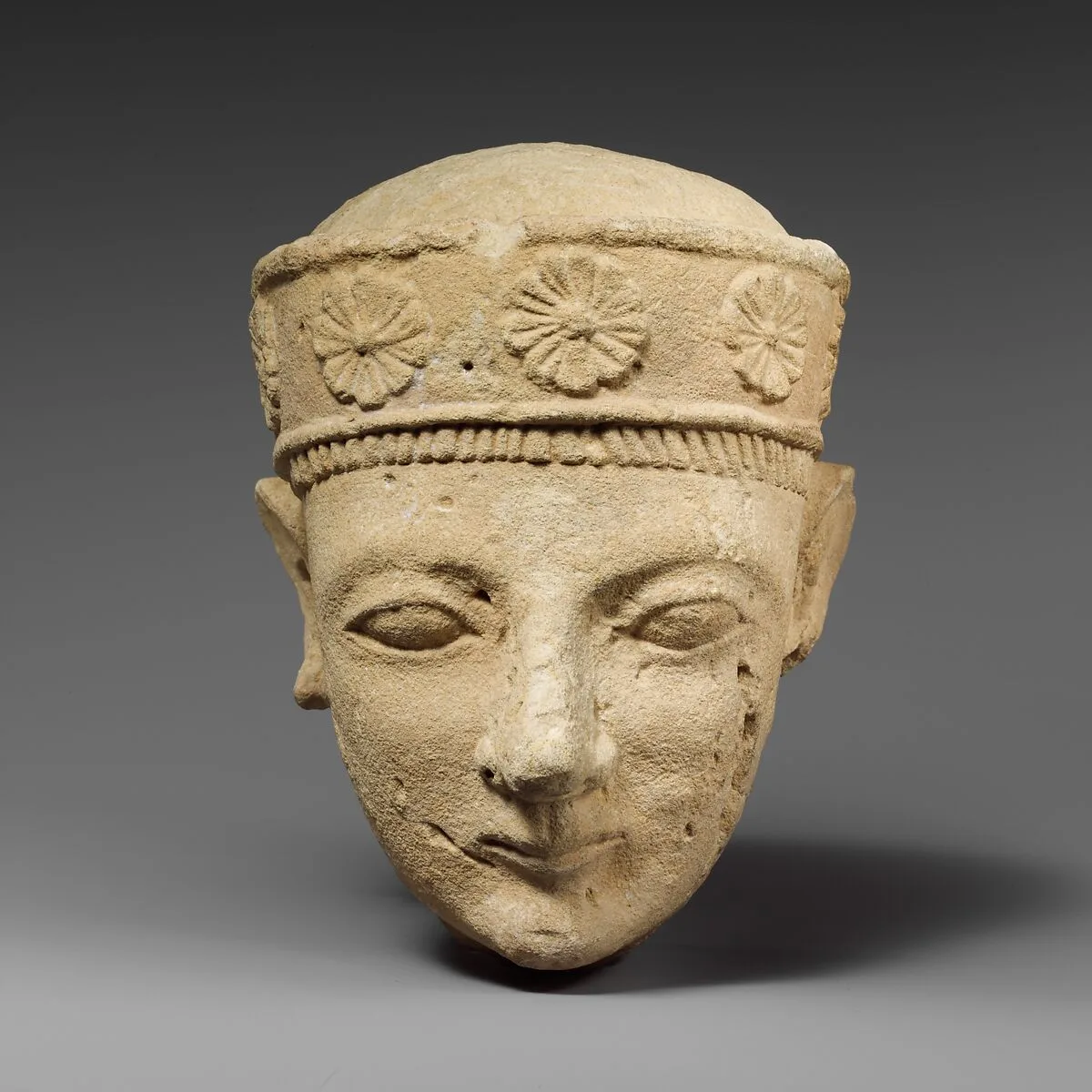 Limestone head of a beardless male with a diadem — Unknown