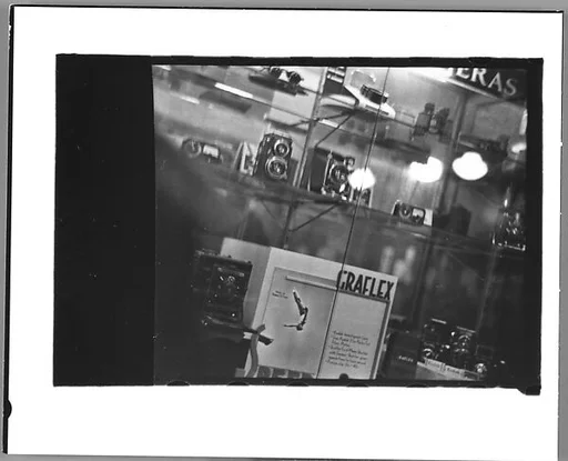 [Five 35mm Film Frames: Camera Store Window, New York City; Subway Passengers, New York City: Women Beneath "7th Avenue Local" Sign ]