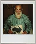 [Walker Evans Holding Arrow Sign]