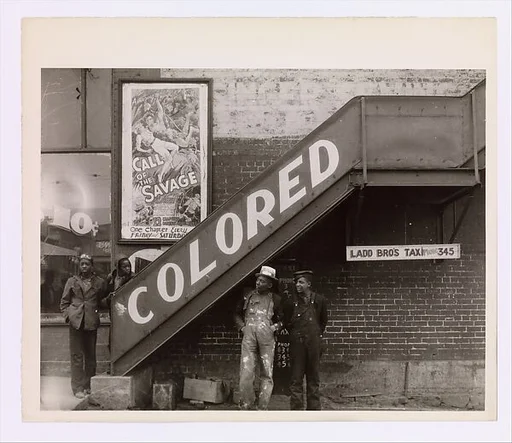 [Young Men at Base of Exterior Stairway to Movie Theater Balcony, Anniston, Alabama]