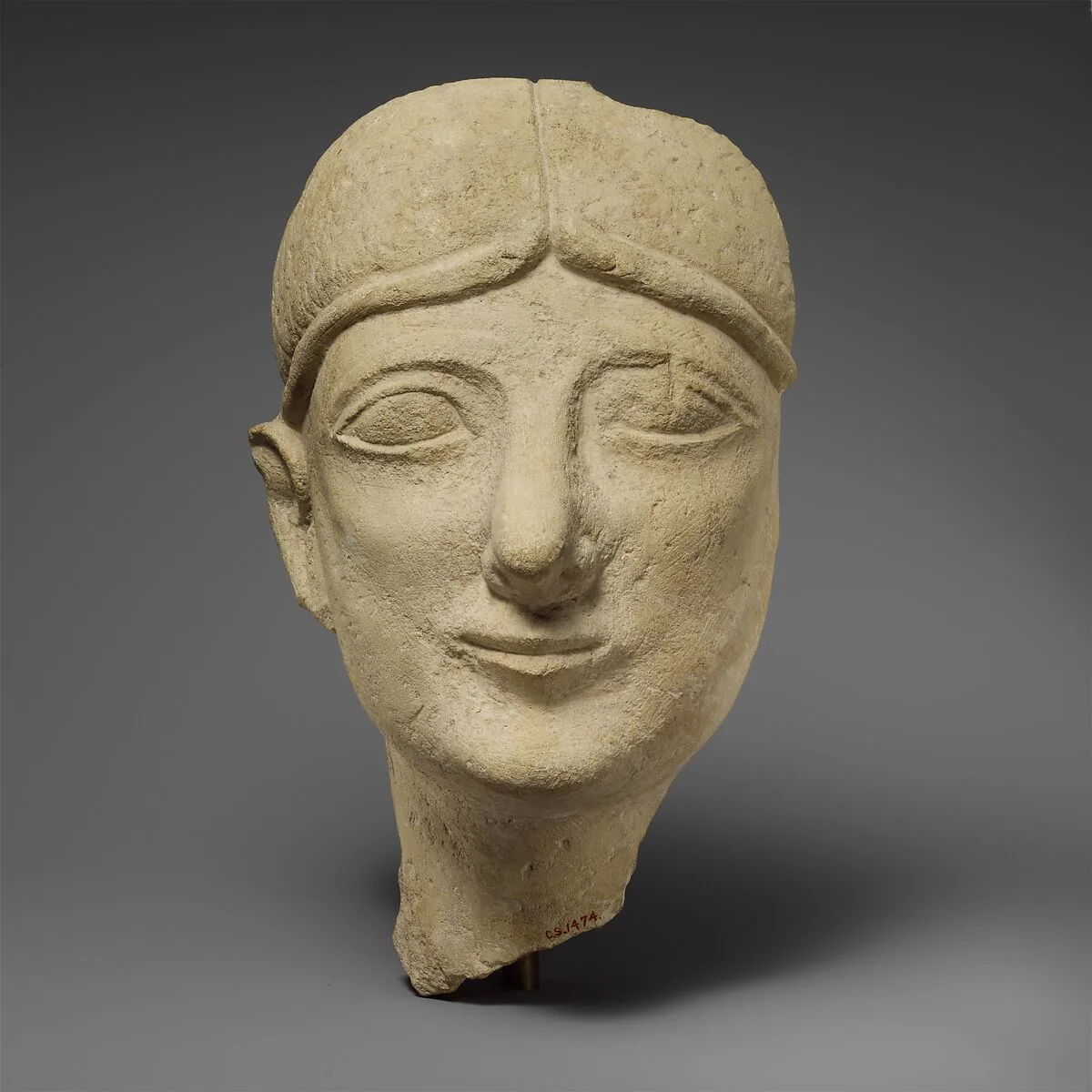 Limestone head of a beardless male with a fillet — Unknown