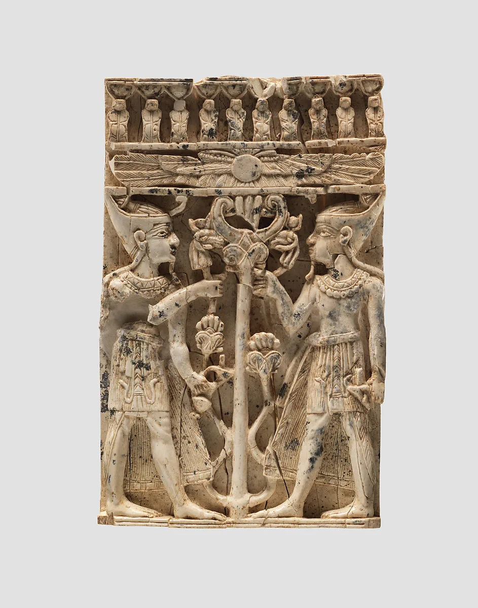 Furniture plaque carved in high relief with two Egyptianizing figures flanking a volute tree — Unknown