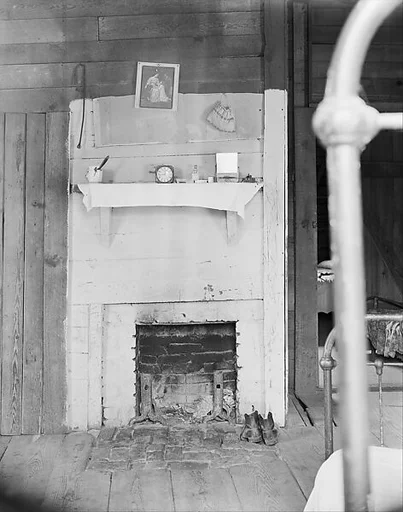 [Fireplace in Floyd Burrroughs's Bedroom with Bedpost in Foreground, Hale County, Alabama]