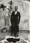 Young man in cravat with potted plant