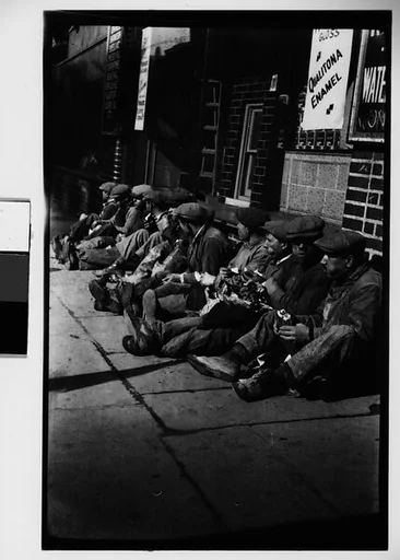 [Workmen Eating Lunch on Sidewalk Underneath Qualitona Enamel Sign, New York City]