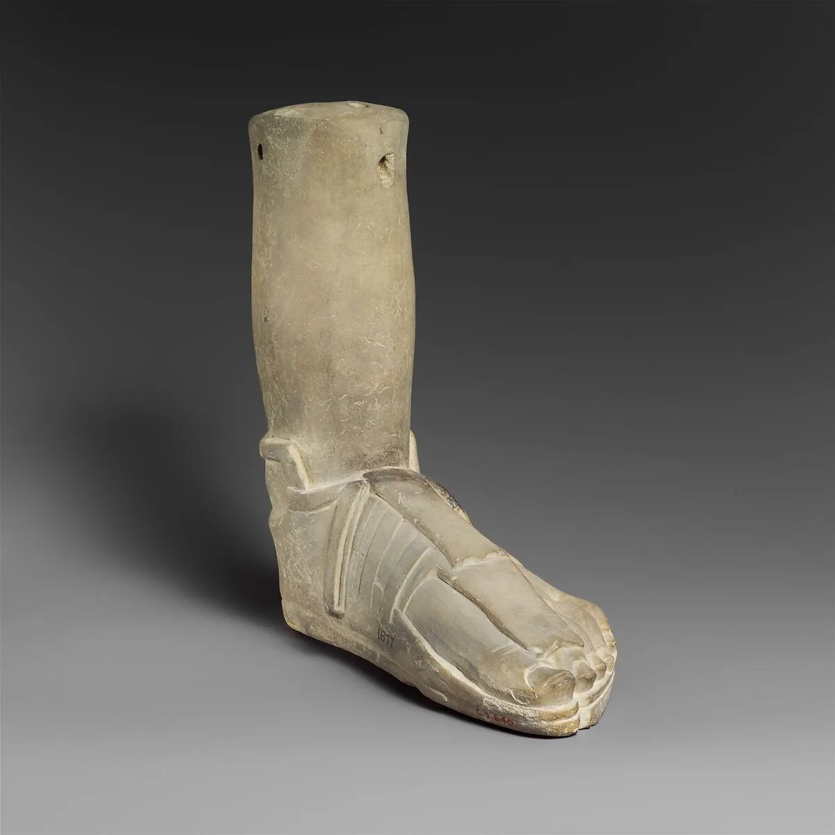 Limestone votive (?) foot with a sandal — Unknown